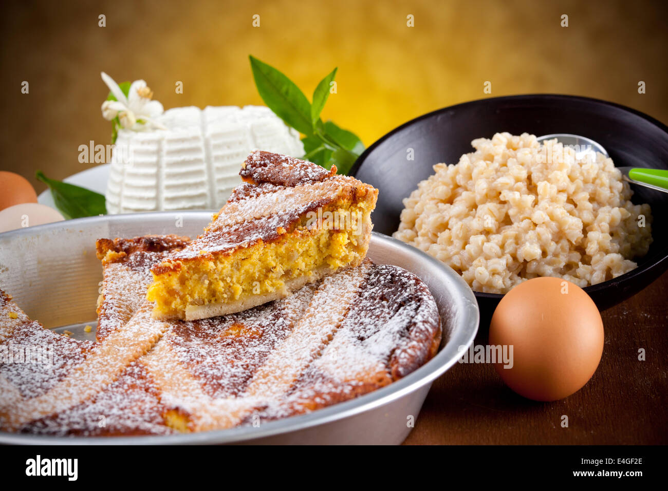 Neapolitan Pastiera with ingredients on wooden table Stock Photo