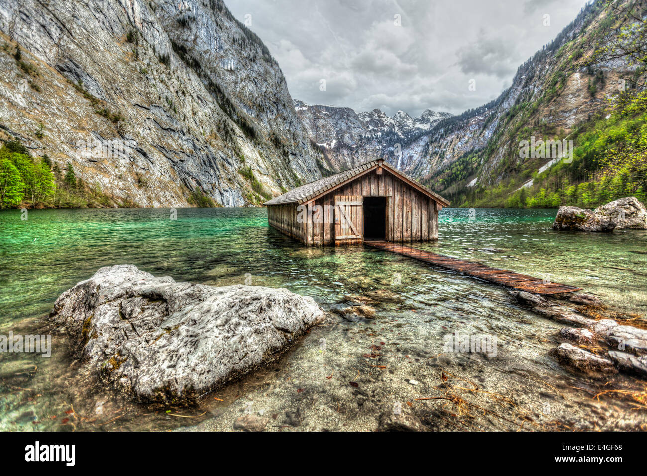 High dynamic range (HDR) image of boat dock hangar on Obersee mountain lake in Alps. Bavaria, Germany Stock Photo