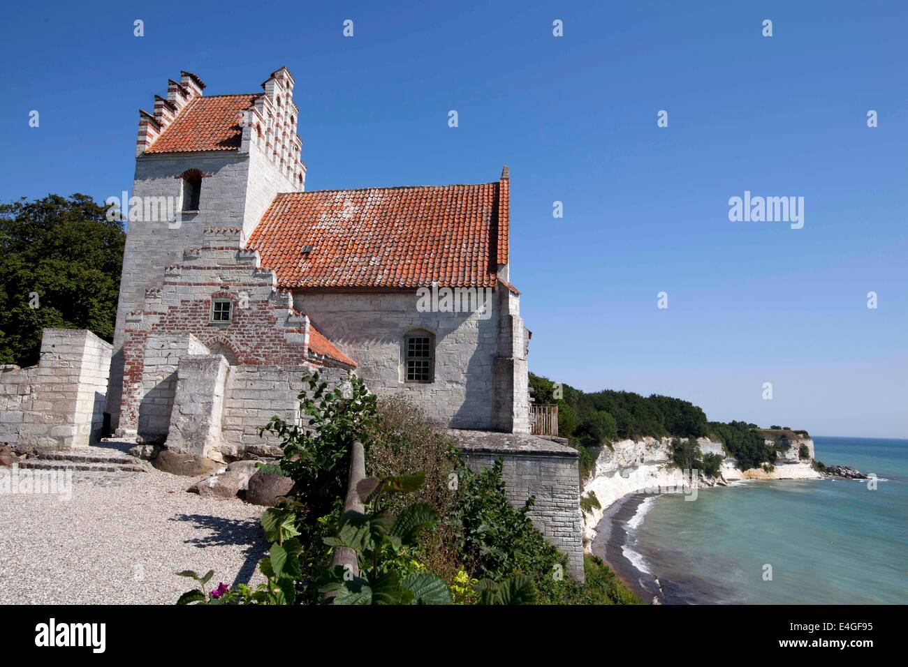 (140711) -- COPENHAGEN, July 11, 2014 (Xinhua) -- Photo taken on July 10, 2014 shows an old church on Stevns Klint in southern Seeland of Denmark. The geological site Stevns Klint comprises a 15 km-long fossil-rich coastal cliff, offering exceptional evidence of the impact of the Chicxulub meteorite that crashed into the planet at the end of the Cretaceous, about 65 millions years ago. Researchers think that this caused the most remarkable mass extinction ever, responsible for the disappearance of over 50% of all life on Earth. Stevns Klint was inscribed on World Heritage List on June, 2014. Stock Photo