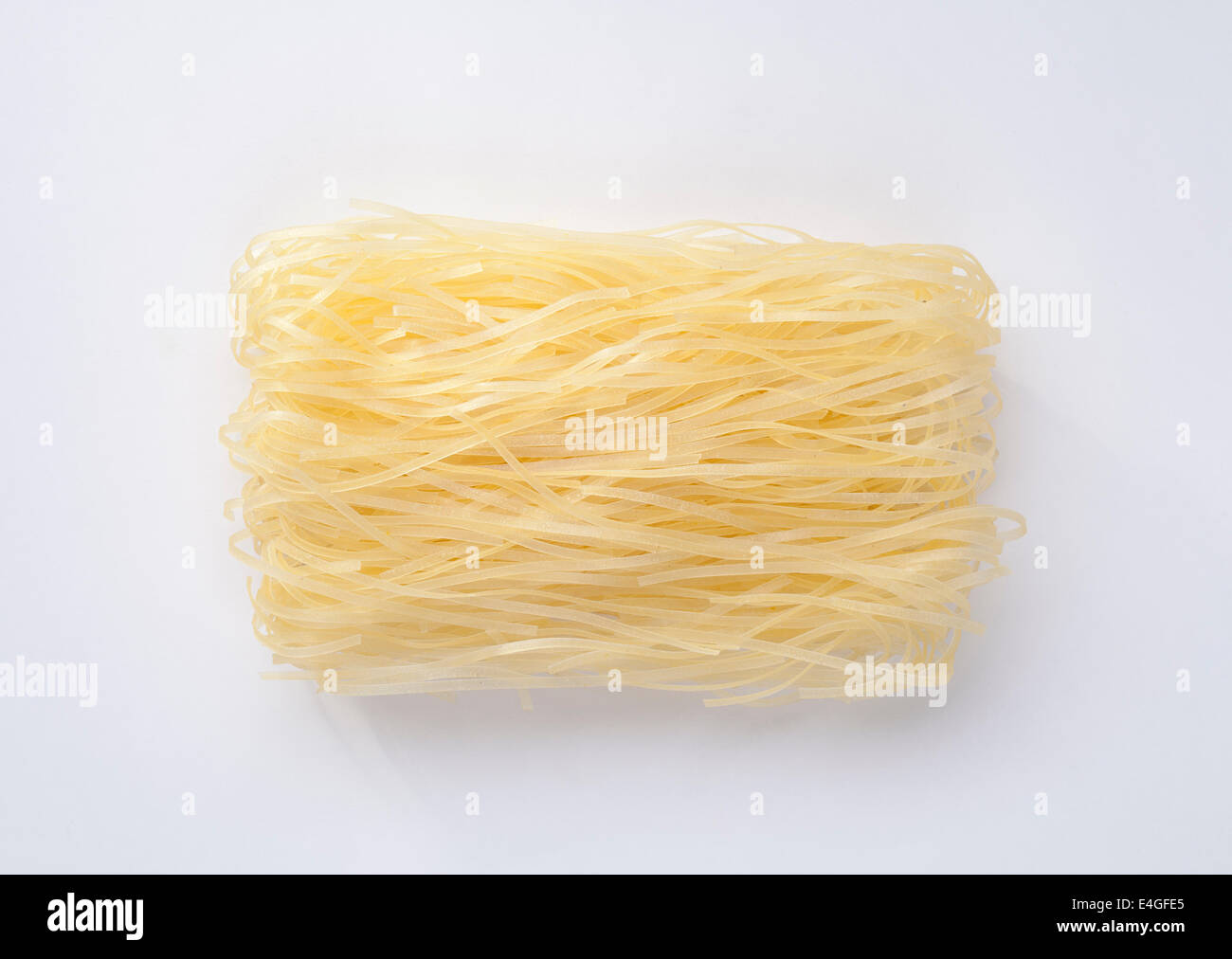 Oriental style instant dried organic noodle sticks isolated on white Stock Photo