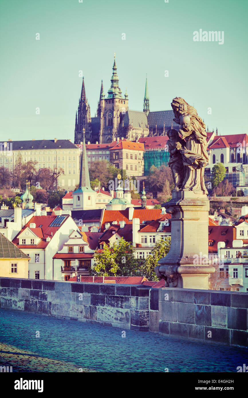 Vintage retro hipster style travel image of statue on Charles Brigde with St. Vitus Cathedral in background in Prague Stock Photo