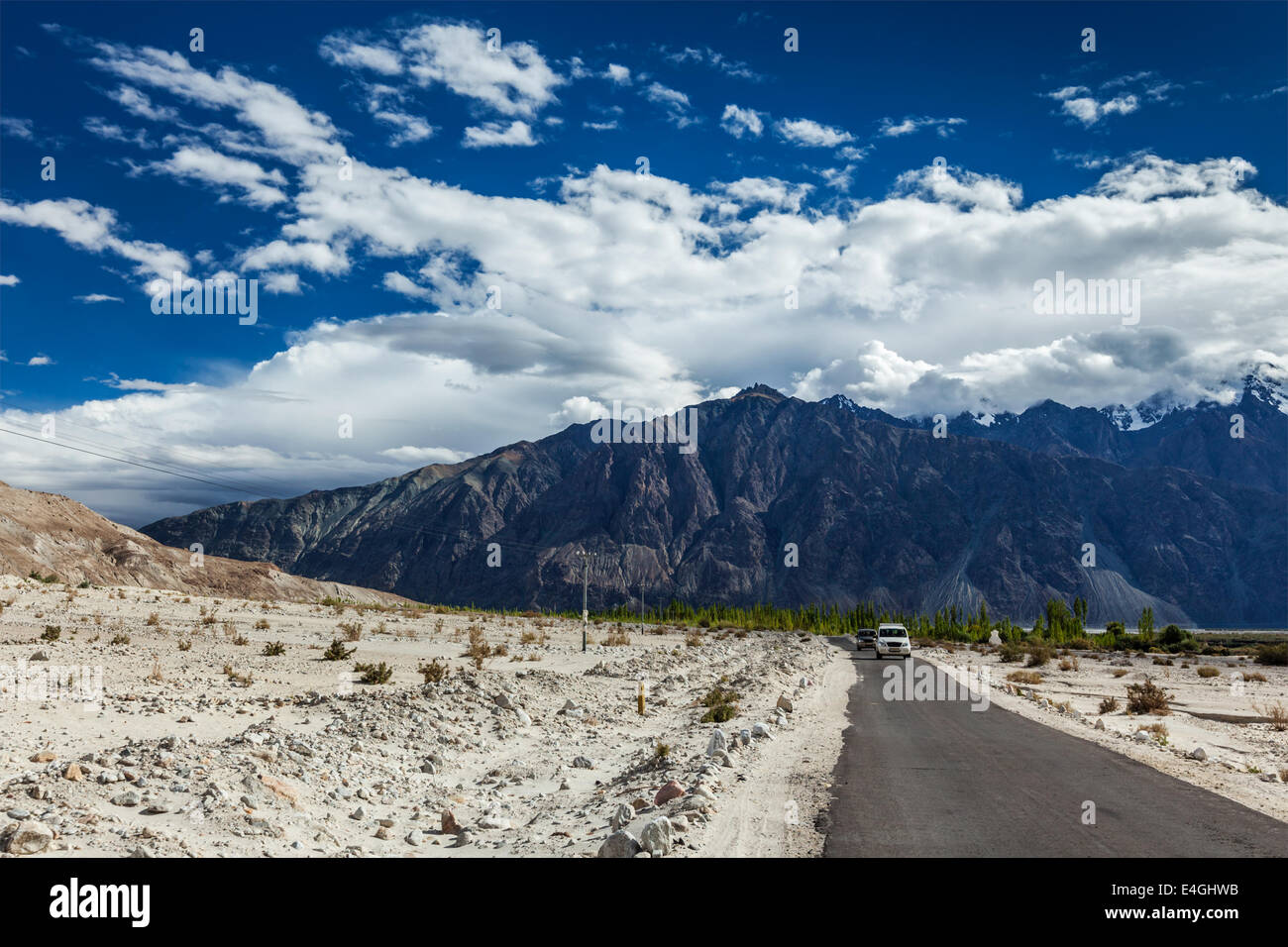 Asphalt road in Himalayas with cars. Nubra valley, Ladakh, India Stock Photo