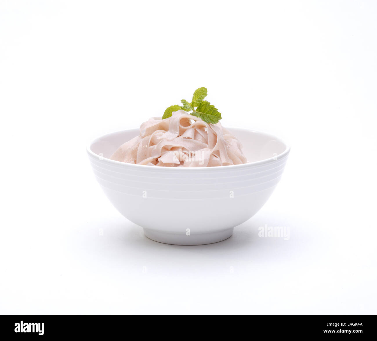 Brown rice noodle in a bowl isolated on white background Stock Photo