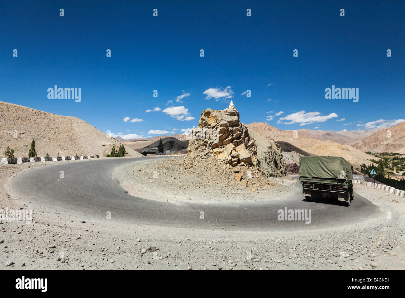 Road in Himalayas with army truck. Ladakh, India Stock Photo