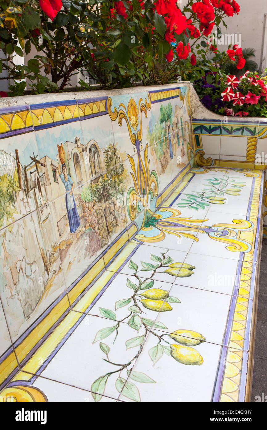 Bench of ceramic tiles decorated with lemons and human figures, Capri. Stock Photo