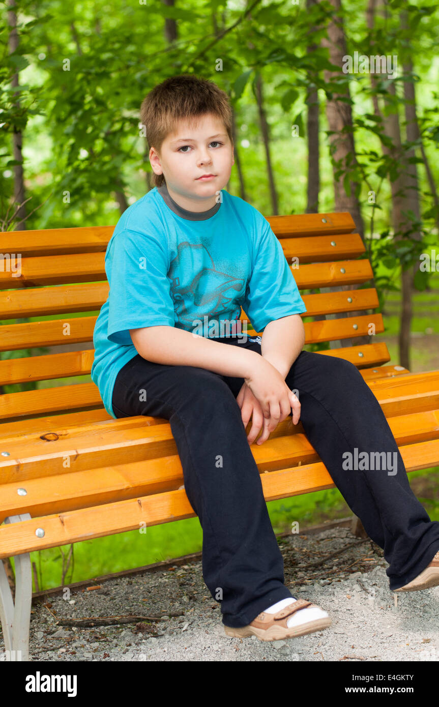 Sad boy on a bench Stock Photo - Alamy