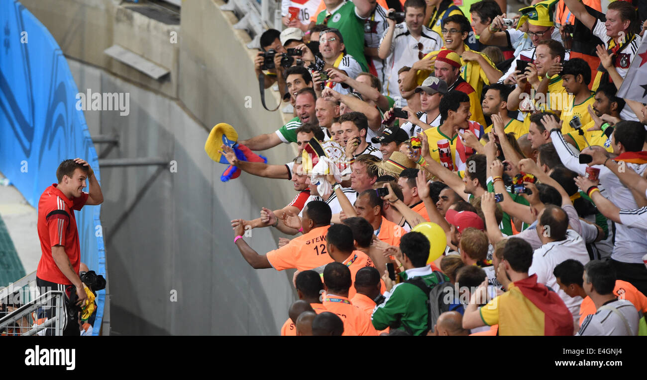 Belo Horizonte, Brazil. 08th July, 2014. Germany's Kevin Großkreutz cheers in front of supporters after the FIFA World Cup 2014 semi-final soccer match between Brazil and Germany at Estadio Mineirao in Belo Horizonte, Brazil, 08 July 2014. At left Marcelo and Maicon. Photo: Andreas Gebert/dpa/Alamy Live News Stock Photo