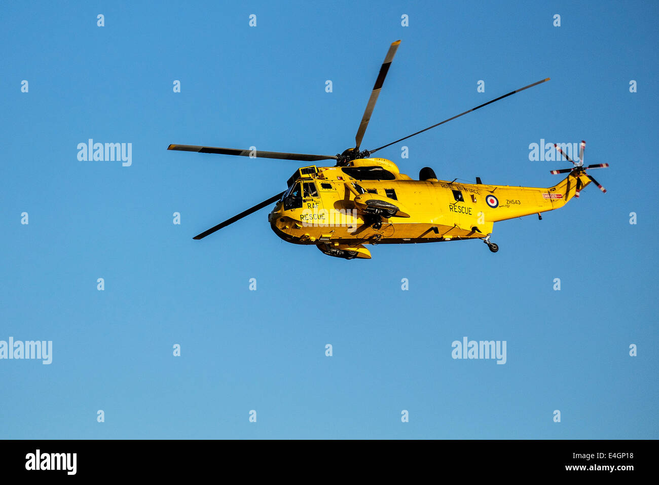 An RAF rescue helicopter flying overhead. Stock Photo
