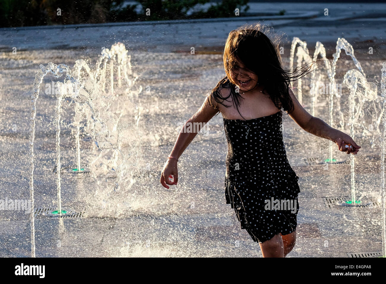 A young girl playing amongst fountains on Southend seafront Stock Photo ...