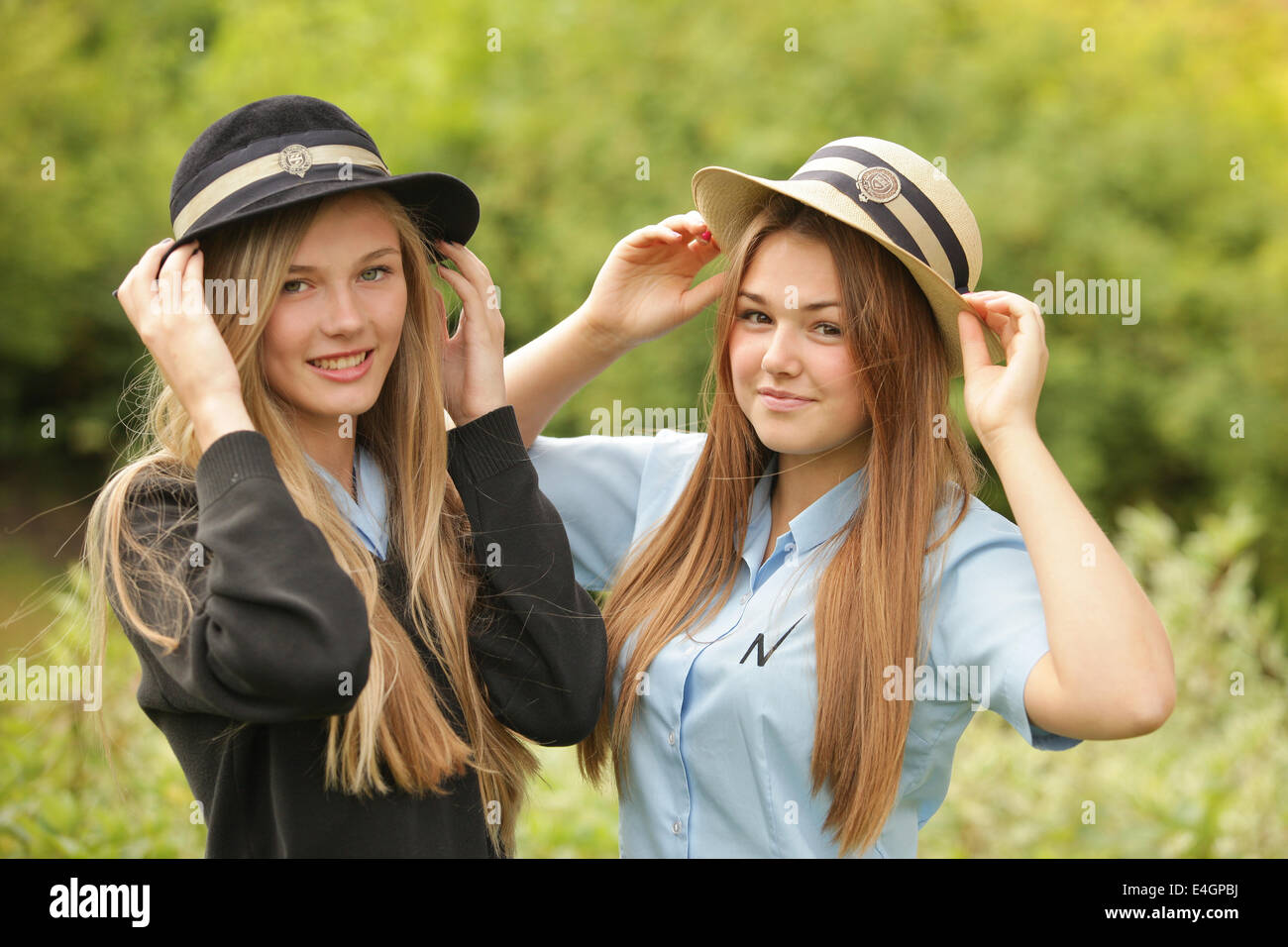 Two British schoolgirls wearing uniform and hats Stock Photo Alamy