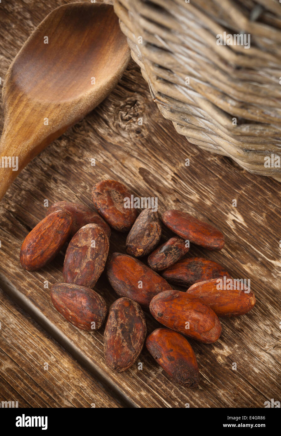 Cocoa beans on wooden table photographed with studio lighting. Stock Photo
