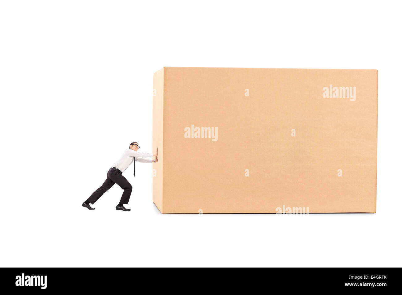 Determined businessman pushing a huge box Stock Photo