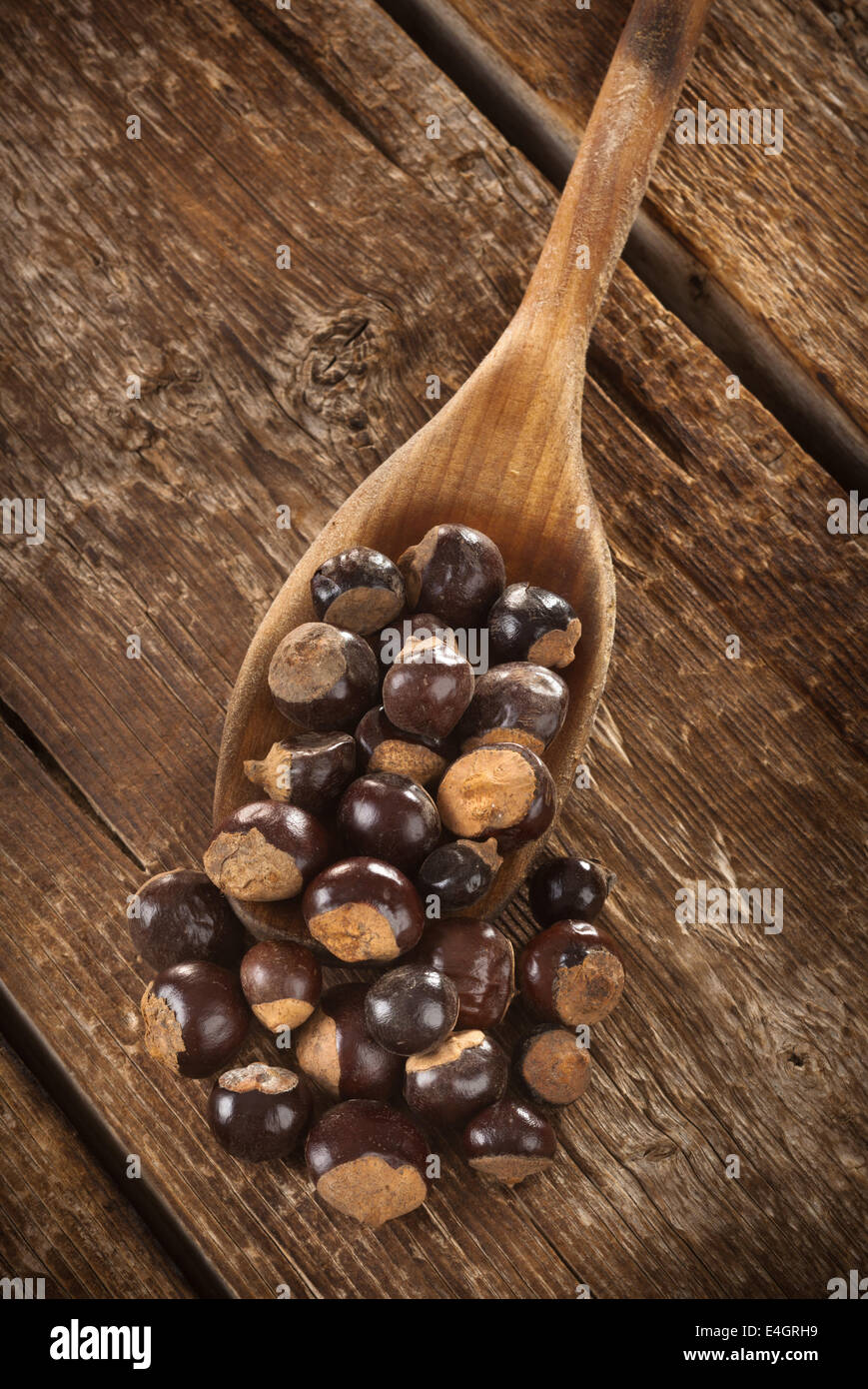 Guarana seeds on wooden table photographed with studio lighting Stock Photo