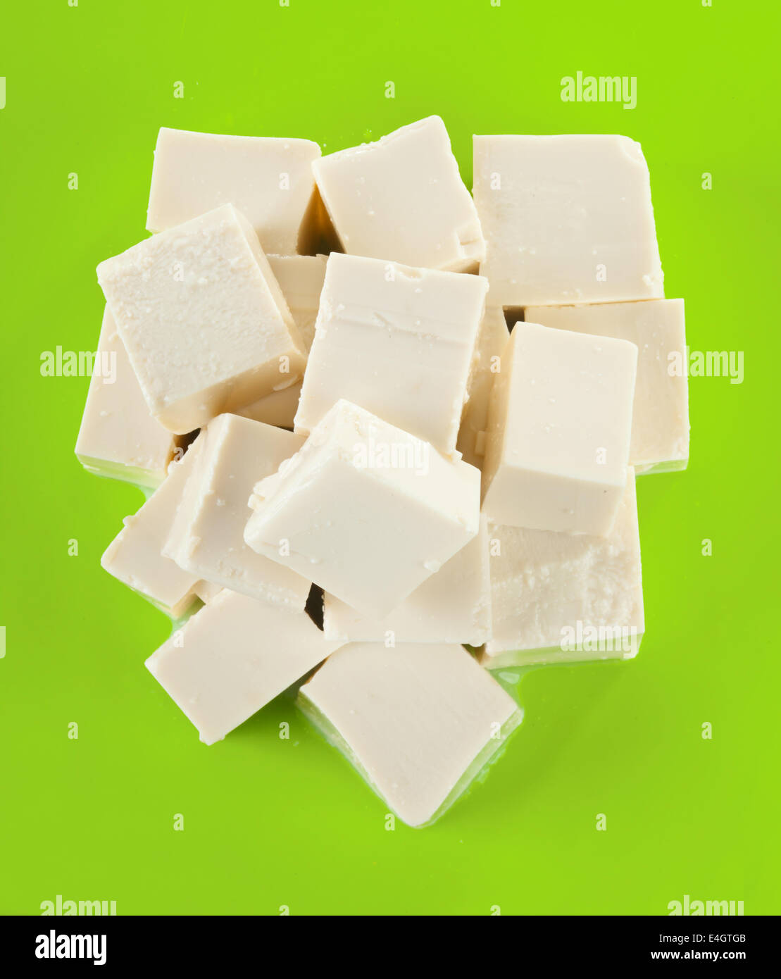 Fresh Tofu cubes of green plastic cutting board Stock Photo Alamy