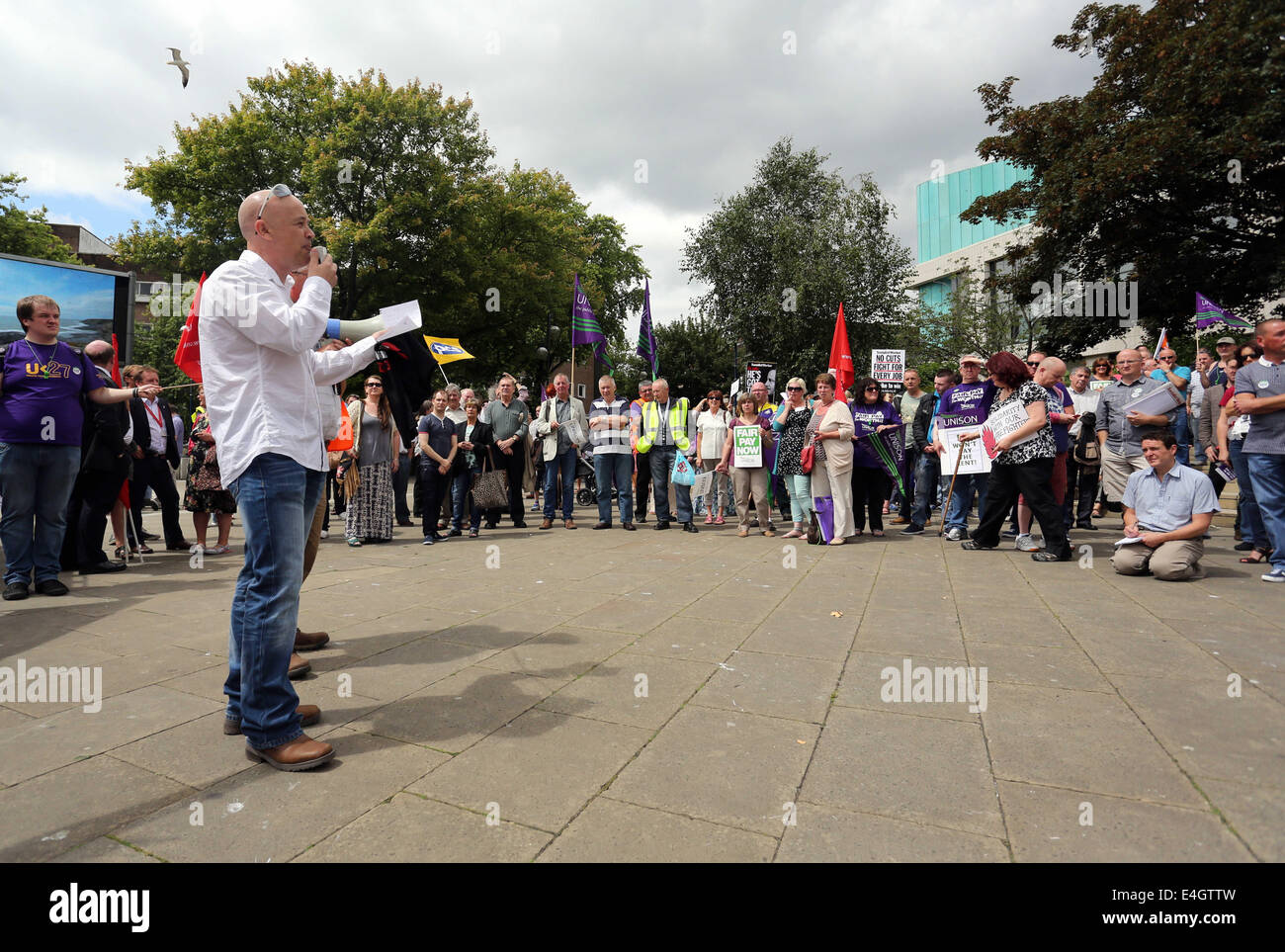 Swansea, UK. 10th July, 2014.  Pictured: Cerith Griffiths of the FBU speaking at Castle Square Gardens, Swansea, south Wales.  Re: Strikes are taking place across the UK in a series of disputes with the government over pay, pensions and cuts, with more than a million public sector workers expected to join the action.  Firefighters, librarians and council staff are among those taking part from several trade unions, with rallies taking place across the UK. Credit:  D Legakis/Alamy Live News Stock Photo
