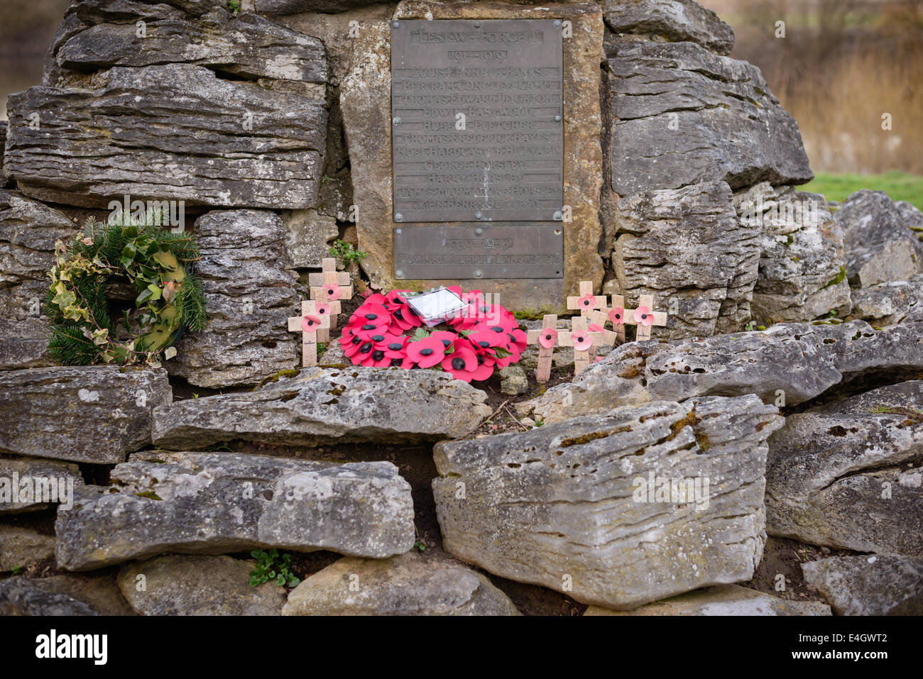 A metal War Memorial with poppies and wooden crosses, in Poppleton, near York, UK. Stock Photo