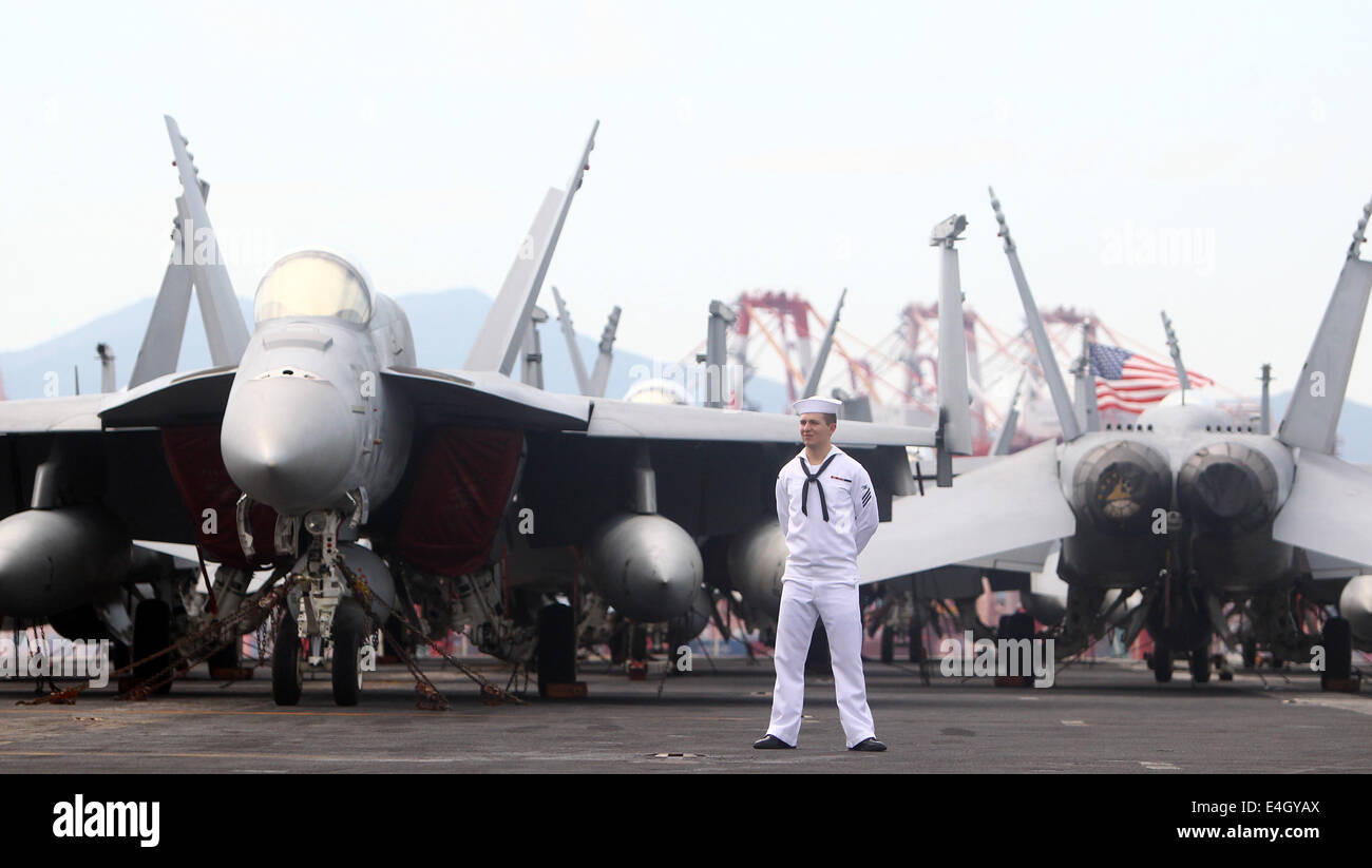 Busan, South Korea. 11th July, 2014. A crew member is seen on the flight deck of US nuclear powered aircraft carrier USS George Washington at a naval port in the southeastern port city of Busan, South Korea, July 11, 2014. The U.S. Navy's aircraft carrier USS George Washington would make a five-day port call to South Korea's southern port city of Busan from Friday and carry out a joint naval exercise with South Korea and Japan. Credit:  Yao Qilin/Xinhua/Alamy Live News Stock Photo