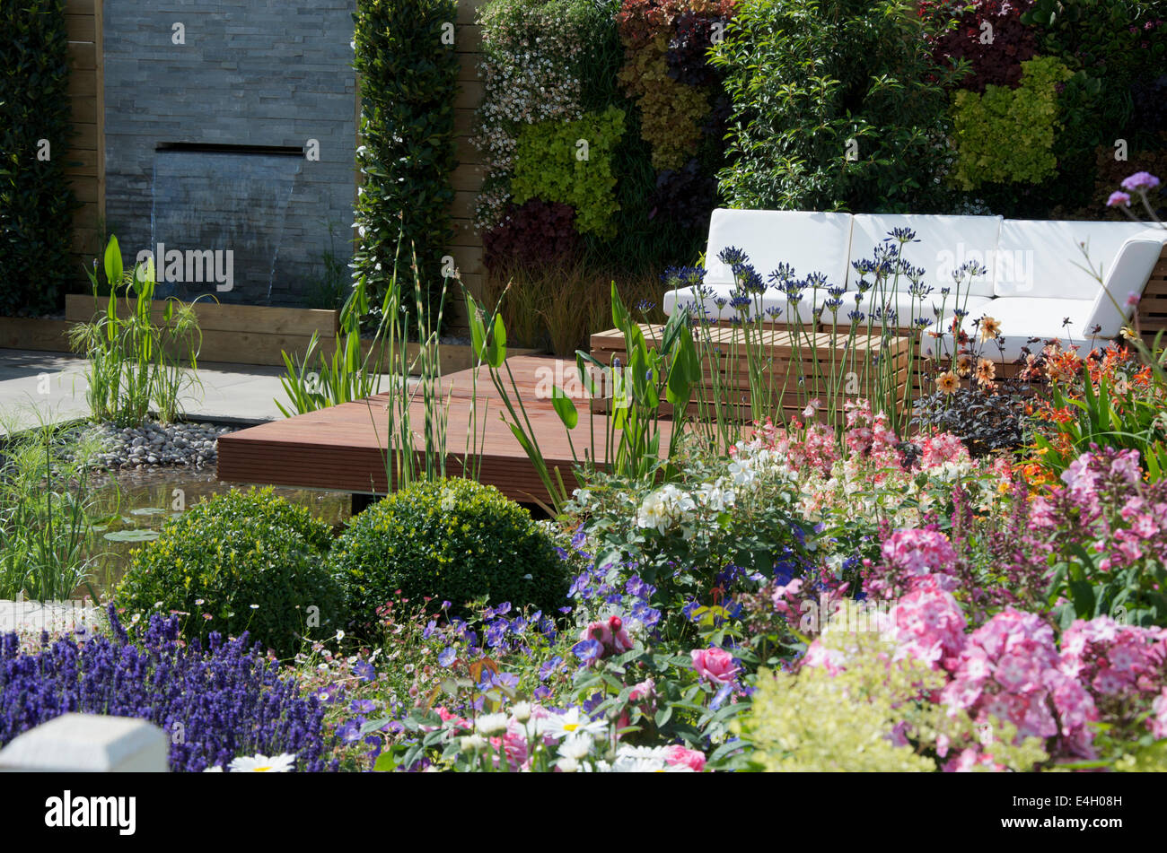 Seating area and water features in A Hampton Garden at RHS Hampton Court Palace Flower Show 2014. Stock Photo