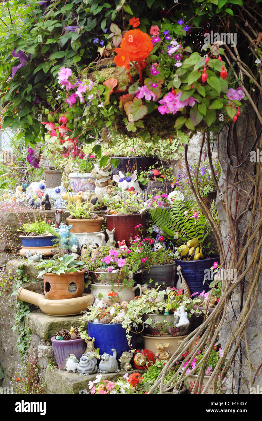 Plants in pots arranged over stone steps outside a traditional stone