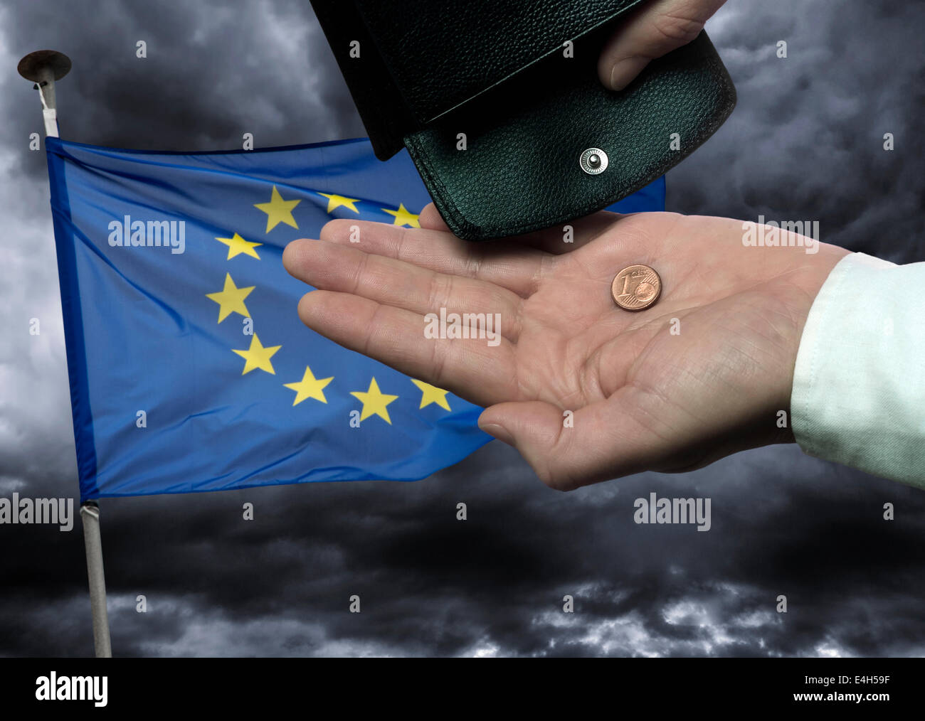 Hand with purse and cents coin before European flag as symbol of an imminent collapse of the European Union. Digital Composite (DC) Stock Photo