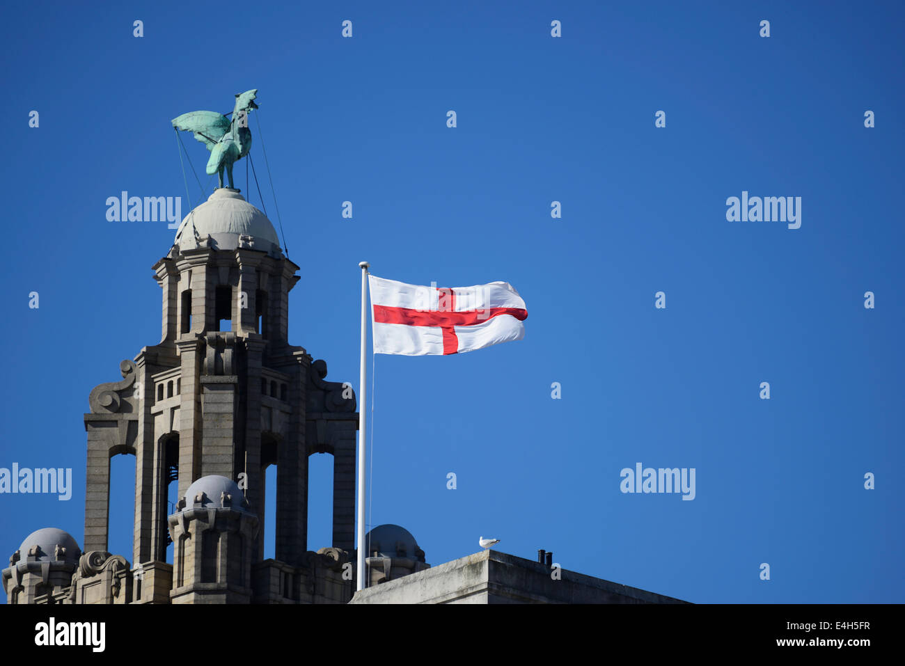 Liverbird on top of the royal liver building at Pier Head in Liverpool with St Georges flag flying in the wind. Stock Photo
