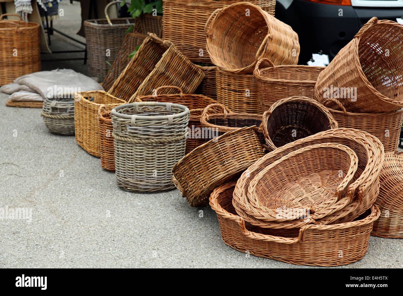 Stacked wicker baskets on sale at an English country town market day
