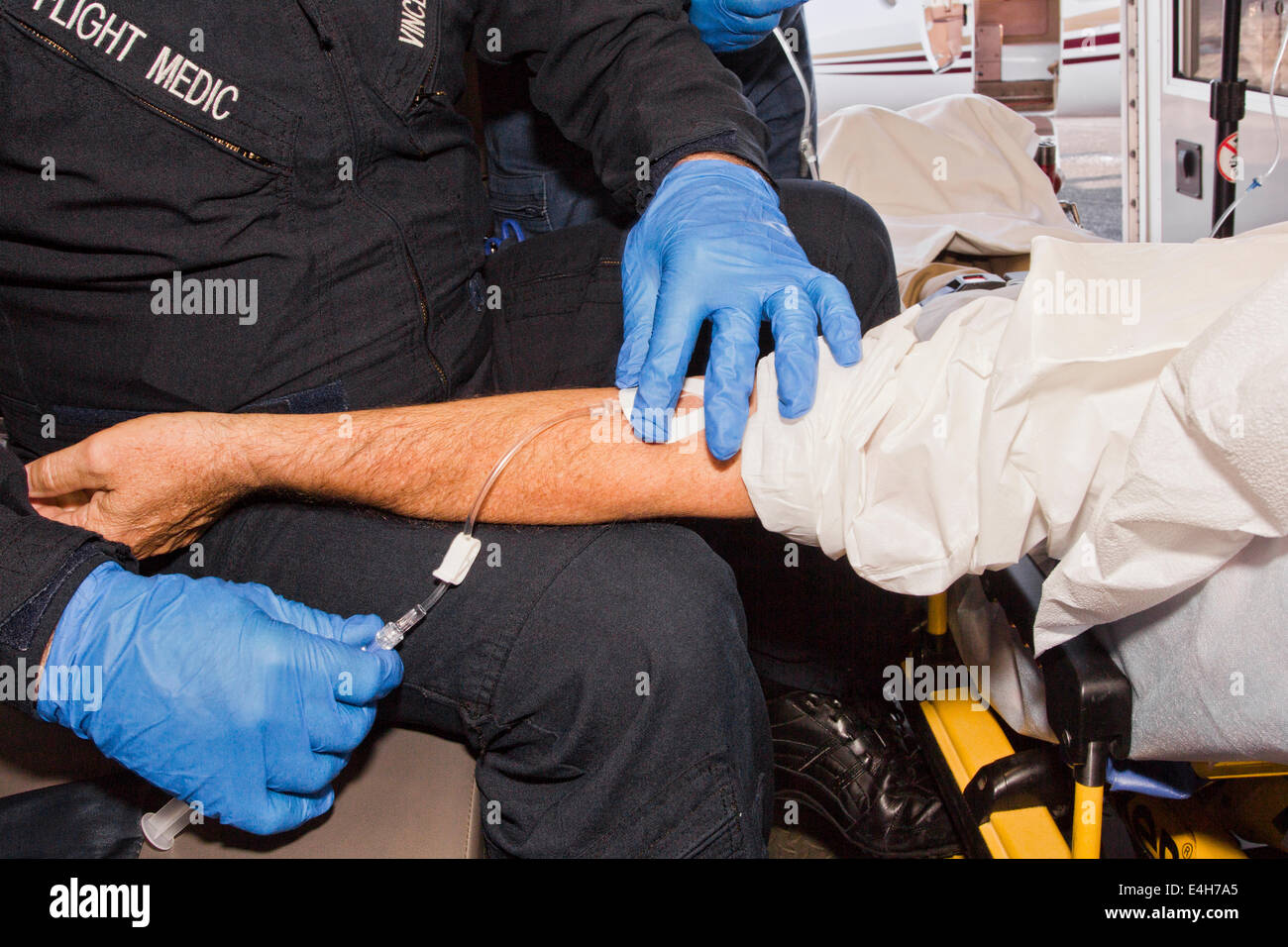A Flight Medic or Paramedic Starting an I. V. on a Sick Patient Stock