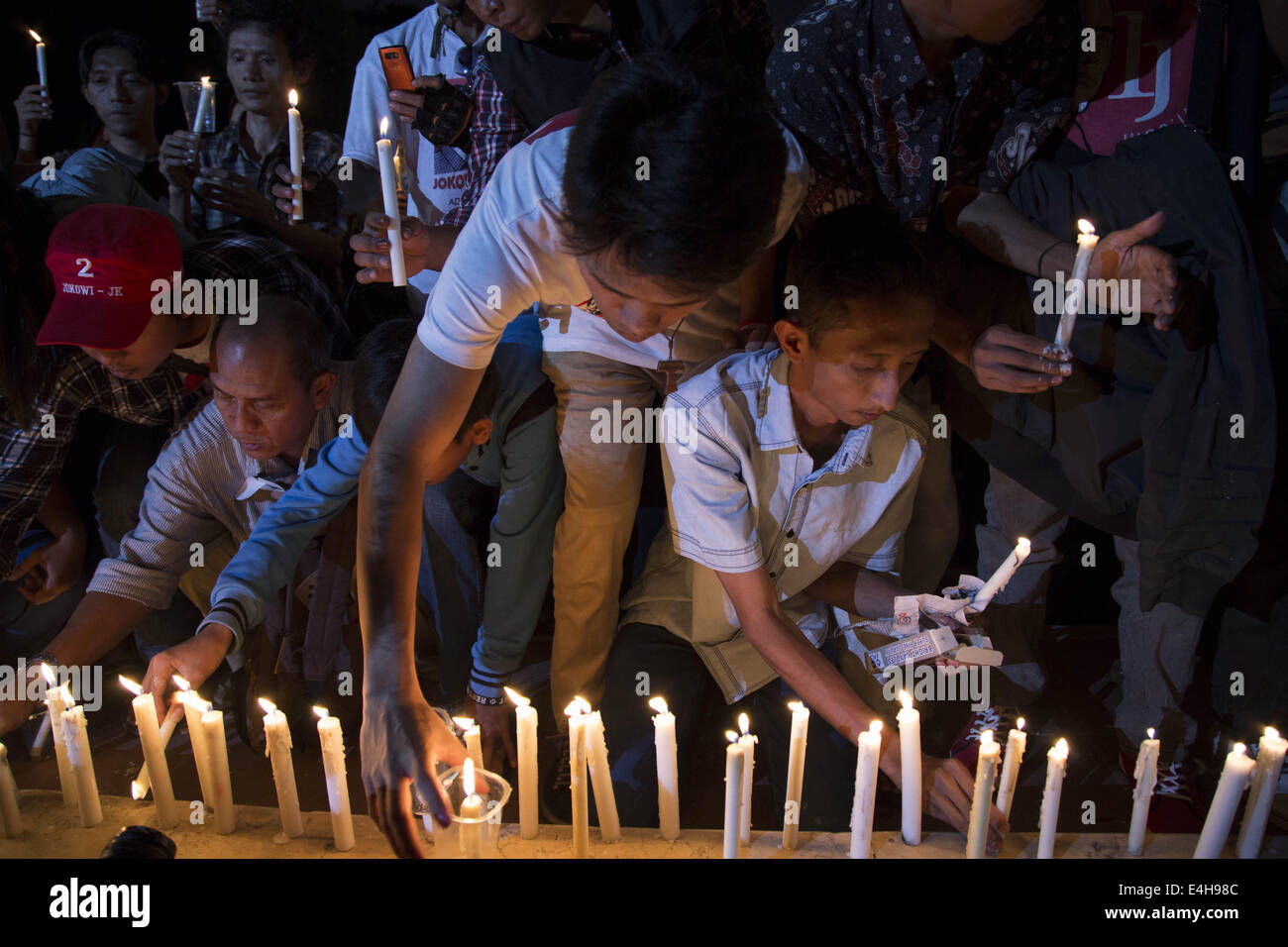 Jakarta, Jakarta, Indonesia. 11th July, 2014. Jokowi Supporters put candle infront of Sukarno-Hatta statue to support palestine. Hundreds of Jokowi supporters gathered at Indonesia Proclamation Monument to lit 1000 candle in supporting the people of palestine that was bombed by Israel Milliter at Gaza. Credit:  Donal Husni/NurPhoto/ZUMA Wire/Alamy Live News Stock Photo