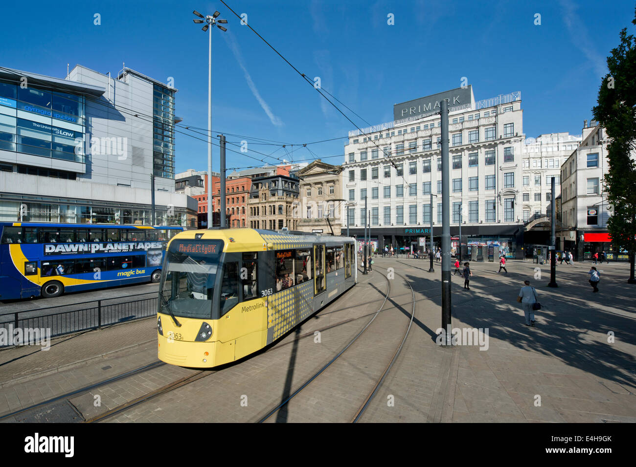 A Metrolink tram enters the Piccadilly Gardens area of Manchester on a sunny morning. Stock Photo