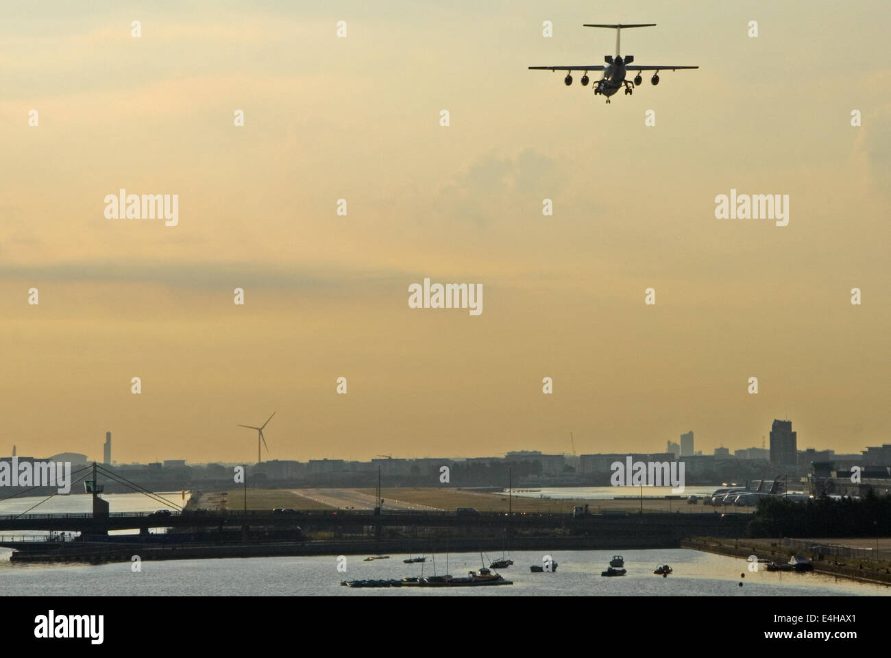 An aeroplane on the approach to London's City airport in the Docklands area of the city Stock Photo