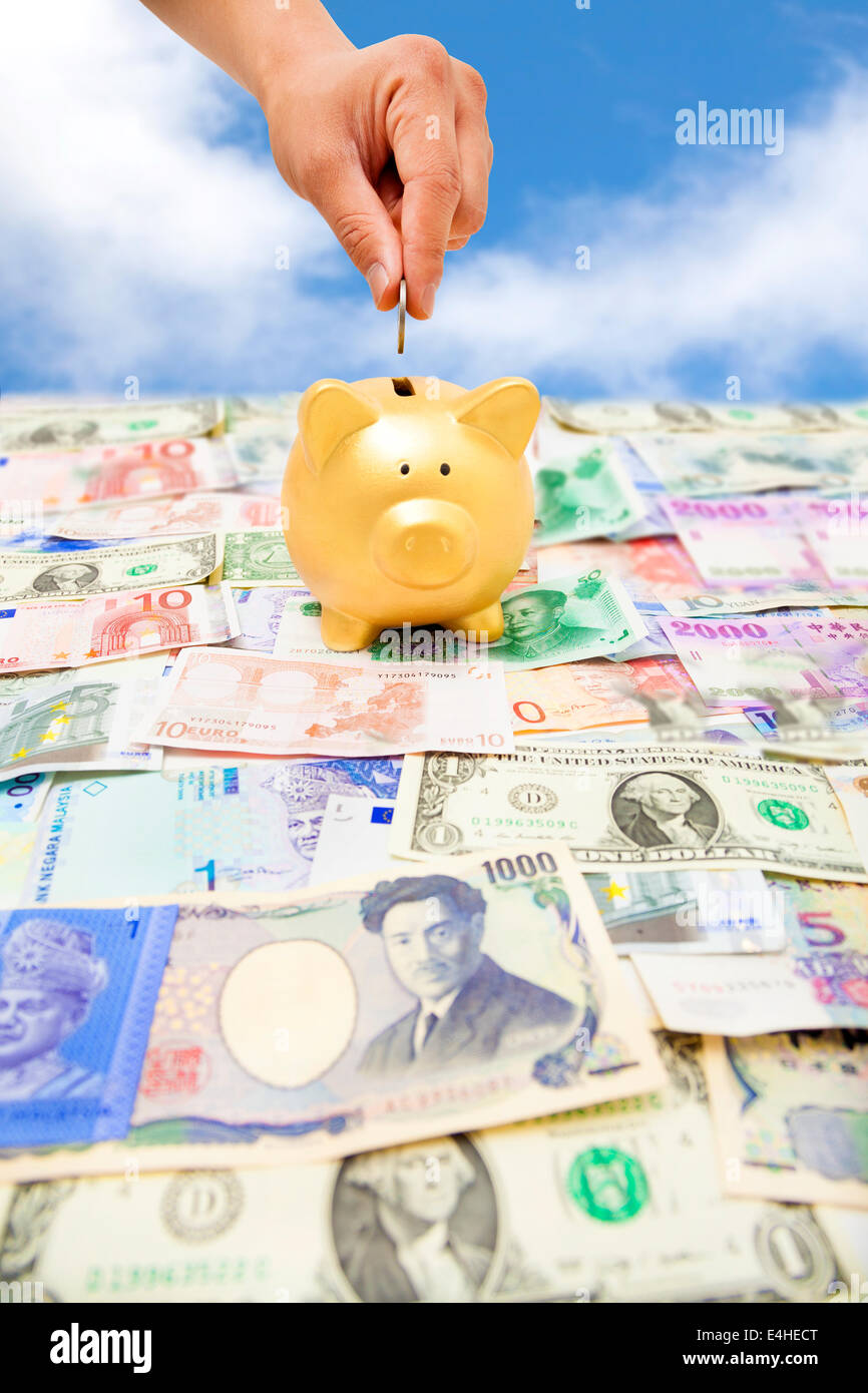 Putting a coin into a piggy bank hi-res stock photography and images - Alamy