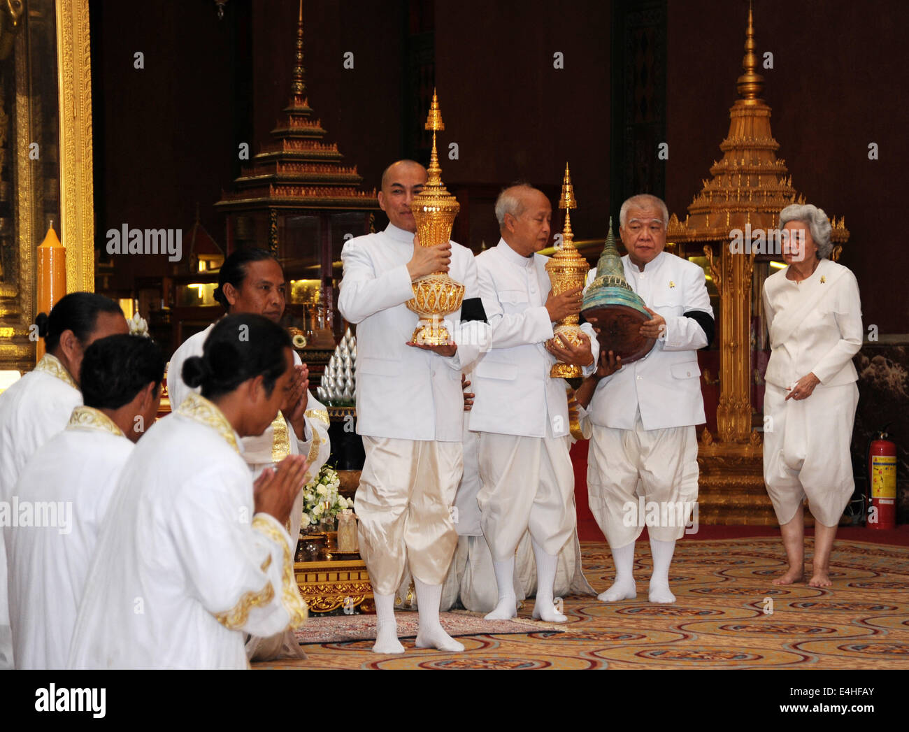 Phnom Penh, Cambodian King Norodom Sihanouk. 12th July, 2014. Cambodian King Norodom Sihamoni (4th R) holds one of the three urns containing the ashes of his father, late Cambodian King Norodom Sihanouk, at the Royal Palace in Phnom Penh July 12, 2014. The remains of Norodom Sihanouk was interred in a stupa in the Royal Palace's Silver Pagoda on Saturday. Credit:  Sovannara/Xinhua/Alamy Live News Stock Photo