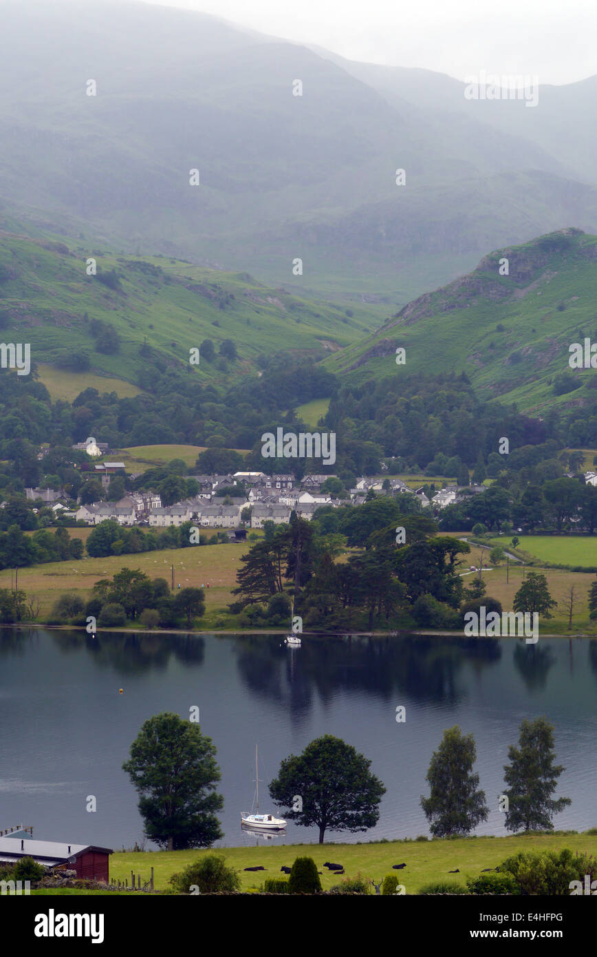 Coniston village with Coniston Water in foreground and Coniston Old Man (mountain) in background. Stock Photo