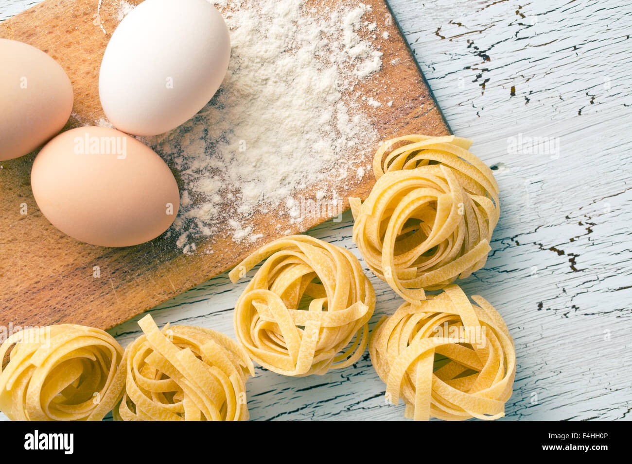 Italian pasta tagliatelle, eggs and flour on old table Stock Photo Alamy