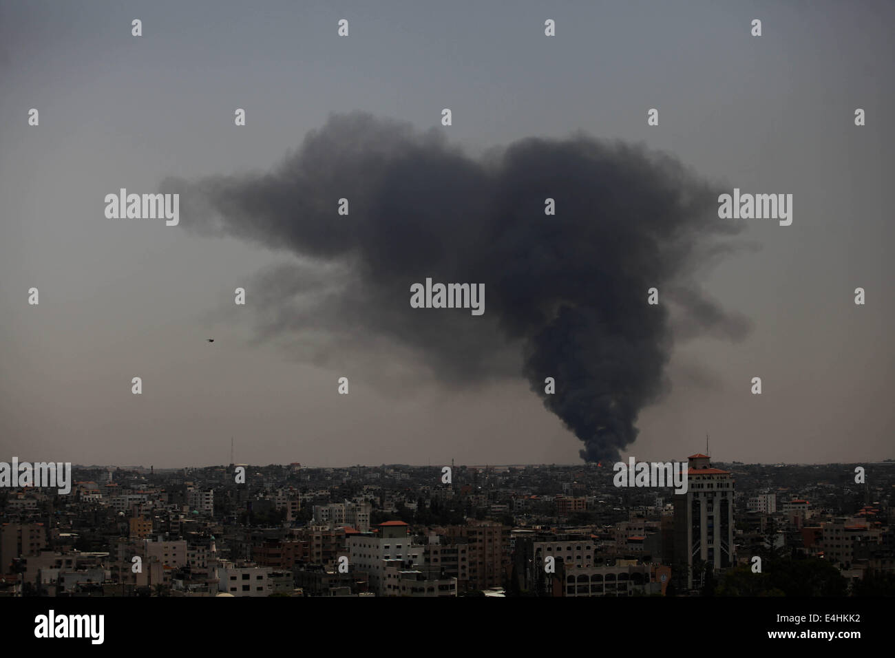 Gaza, Palestinian Territory. 12th July, 2014. Smoke rises following an Israeli strike on Gaza, seen from the Israel-Gaza border, Saturday, July 12, 2014. Israeli airstrikes targeting Hamas in Gaza hit a mosque its military says concealed the militant group's weapons, in an offensive that showed no signs of slowing down. Israel launched its campaign five days ago to stop relentless rocket fire on its citizens. While there have been no fatalities in Israel, Palestinian officials said overnight attacks raised the death toll there to over 120, with more than 920 wounded. (Credit Imag Stock Photo