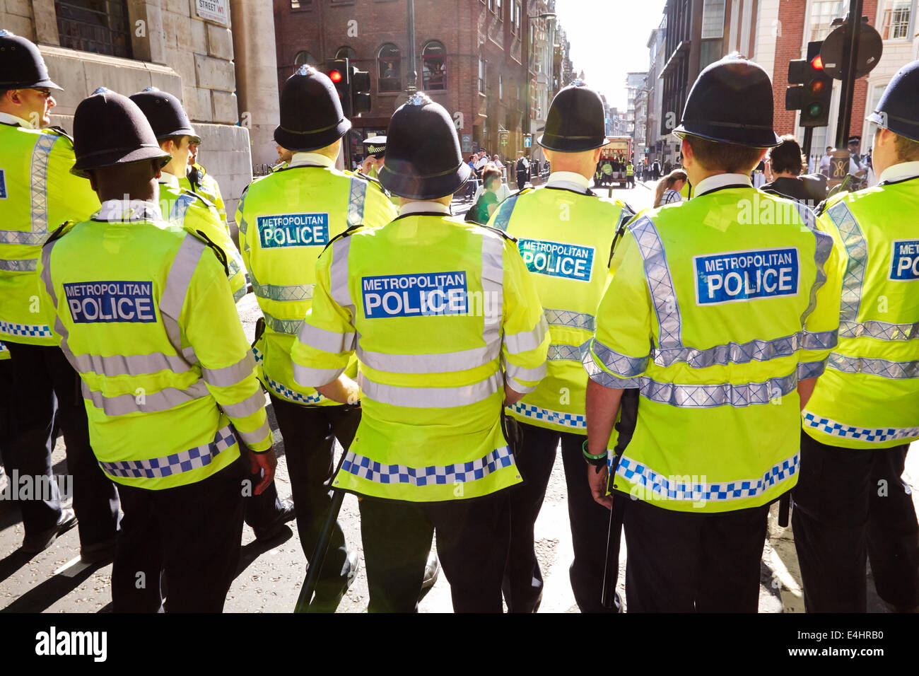 Line of Metropolitan police officers seen from behind Stock Photo