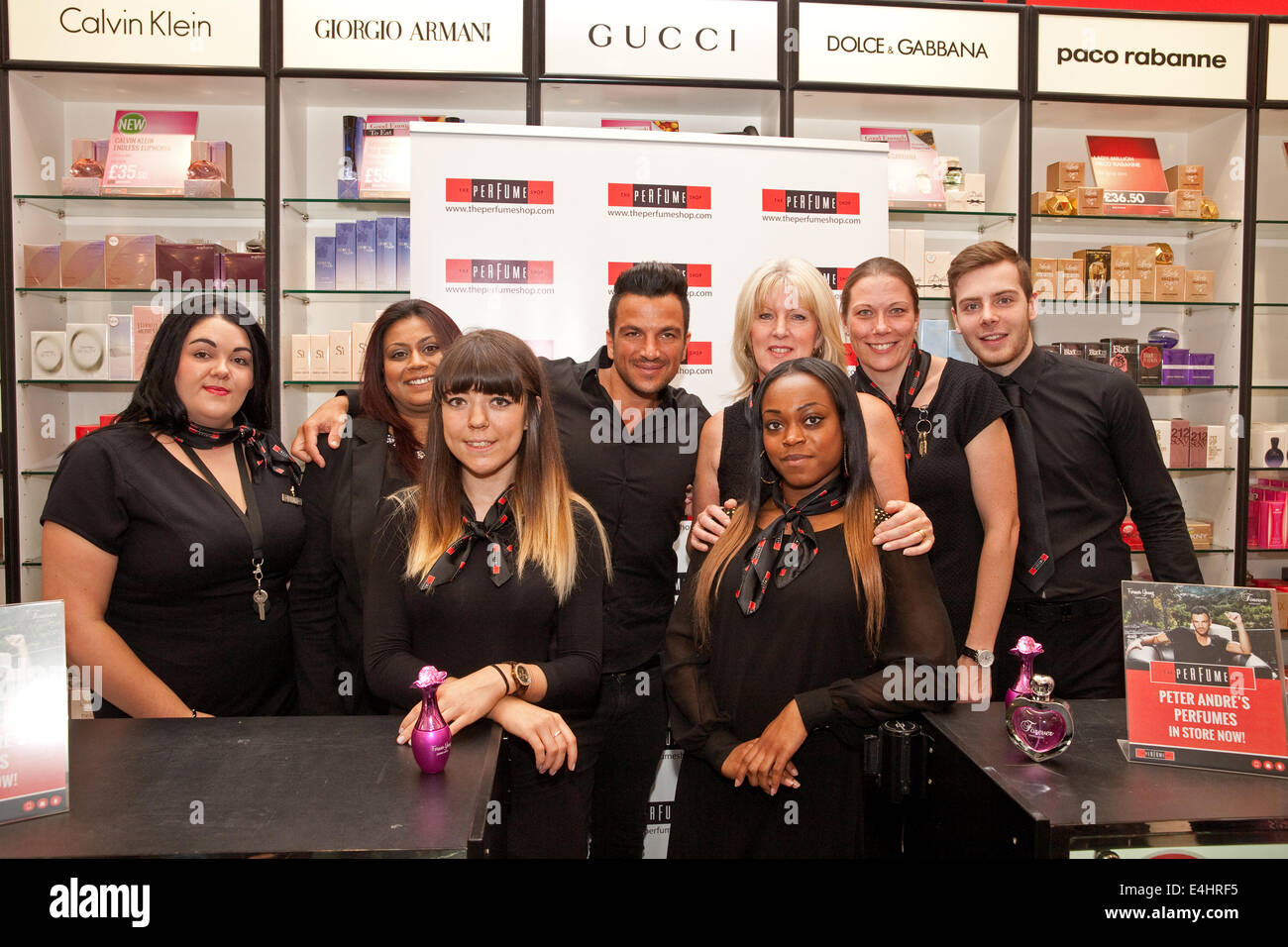 Bromley UK.12th July 2014. Peter Andre poses with members of staff as he launches his