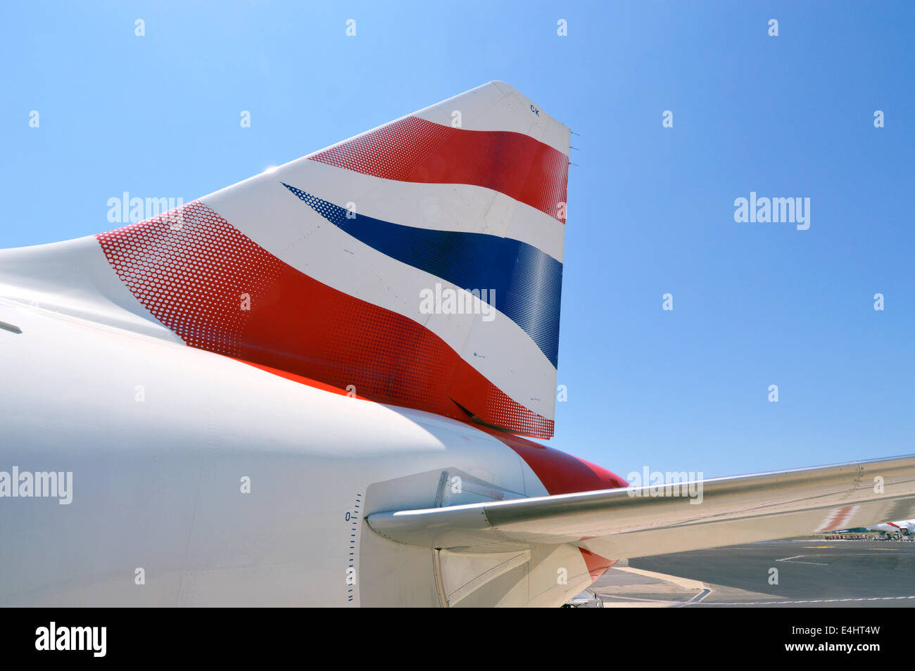 Close up of plane with red white blue British Airways corporate business BA logo on airplane tail fin against blue sky at Rome Airport Italy Stock Photo