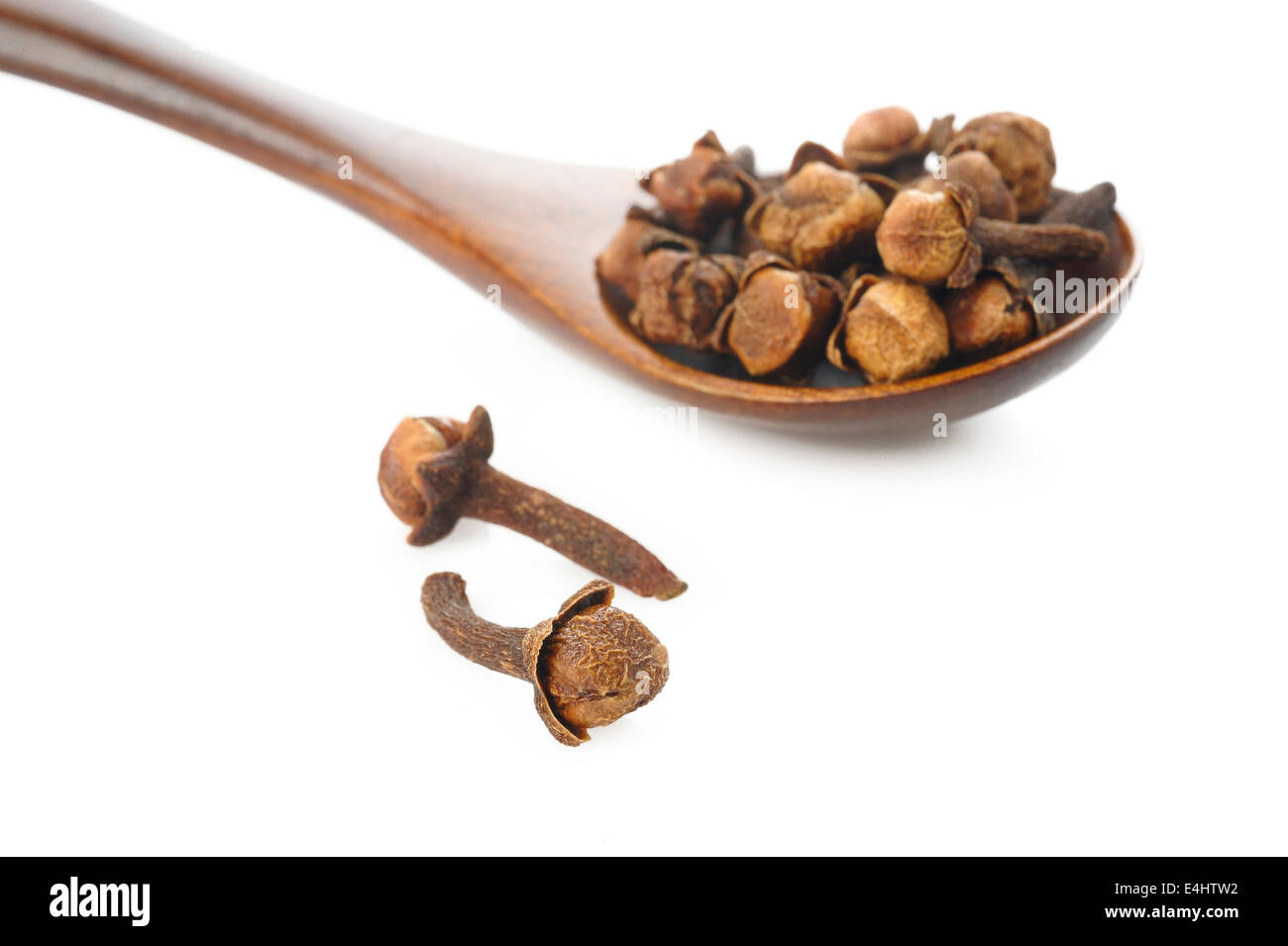 clove spices and wooden spoon isolated on white background Stock Photo
