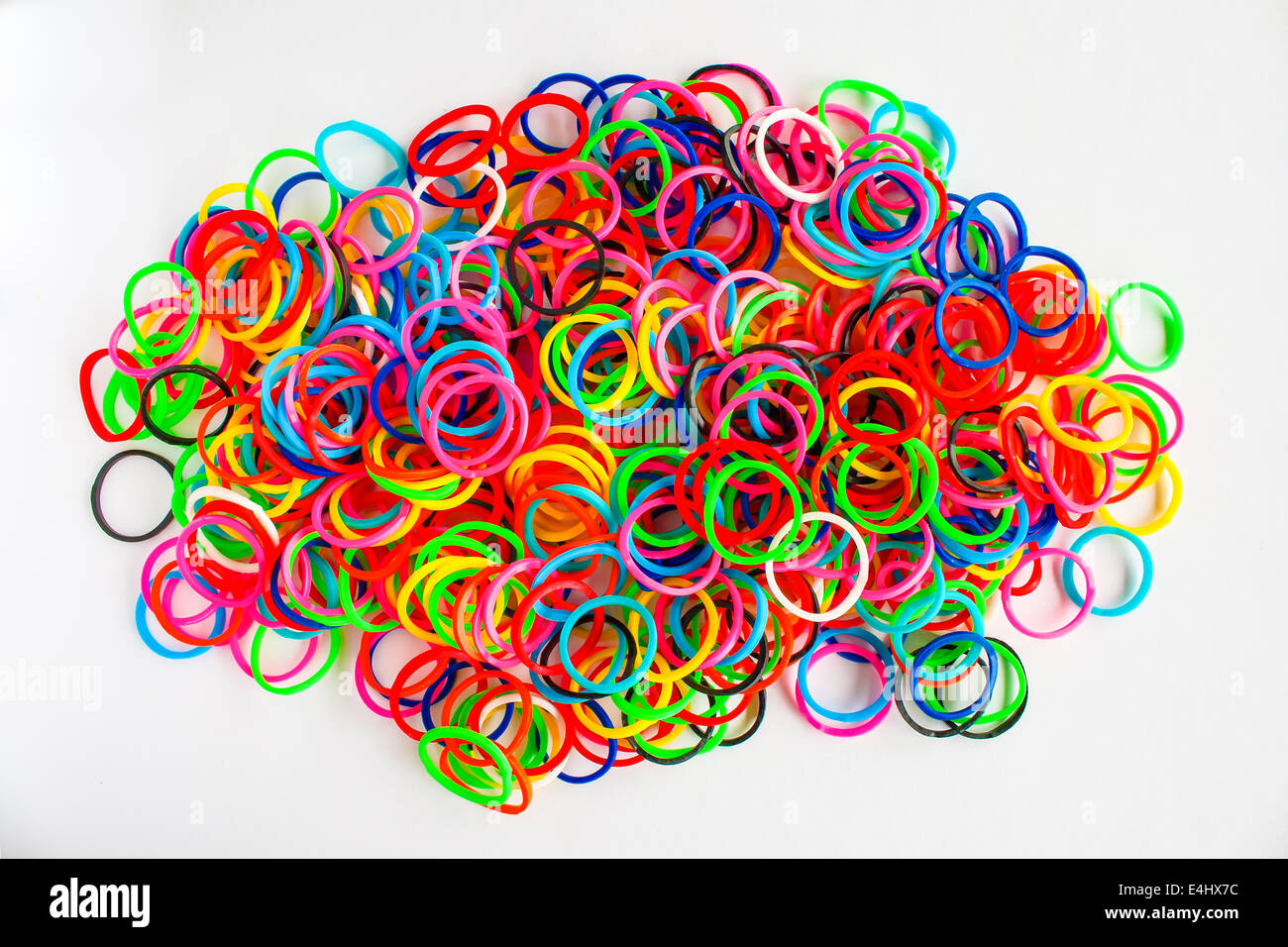 Premium Photo  Pile of small round colorful rubber bands for making  rainbow loom bracelets isolated on dark background