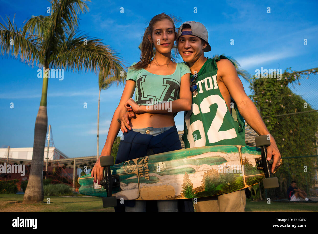 Skaters lovers teenagers at Green area in Cinta Costera Pacific Ocean Coastal Beltway Bahia de Panama linear park seawall skylin Stock Photo