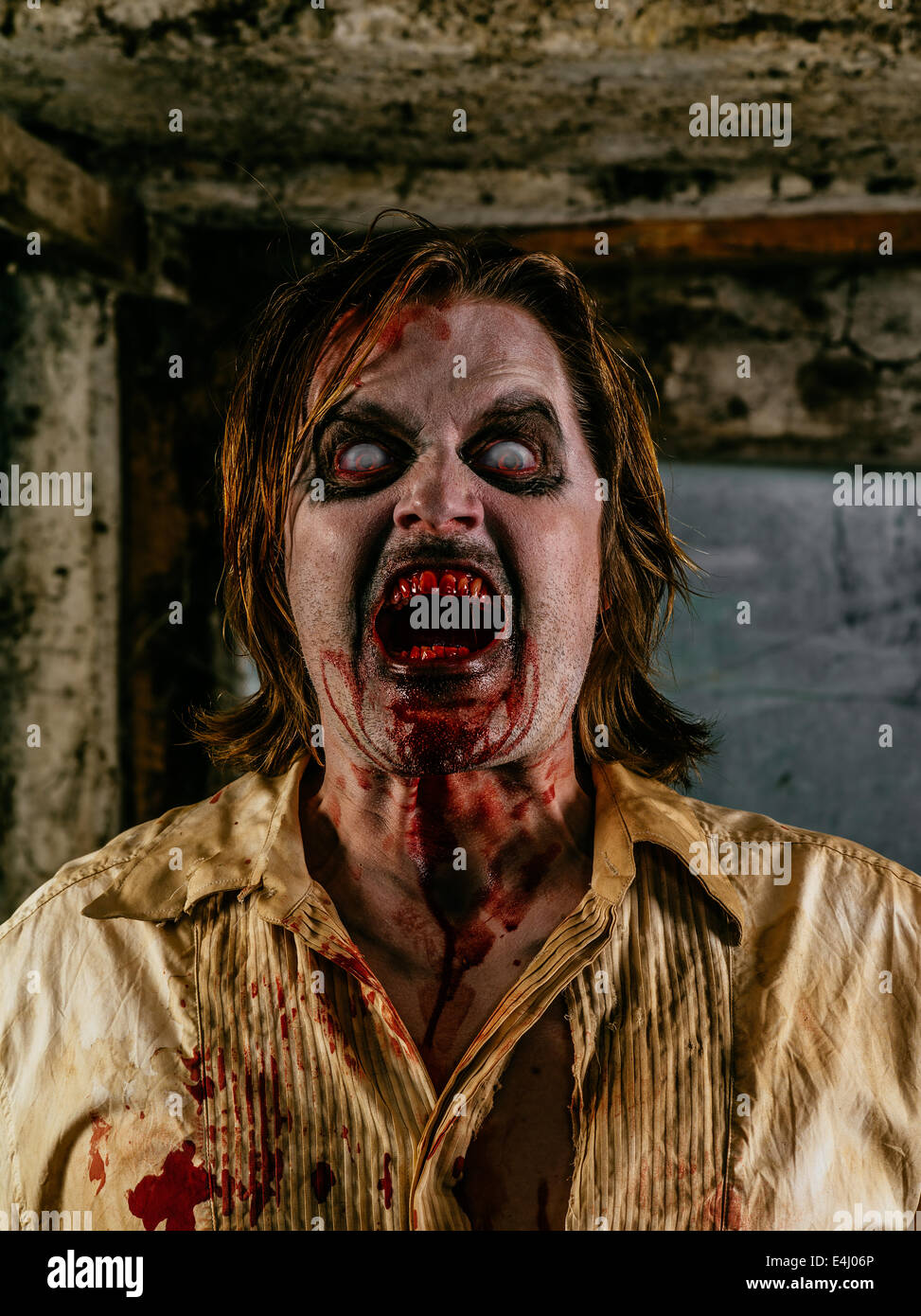 Photo of a hungry zombie covered with blood about to attack you. Stock Photo