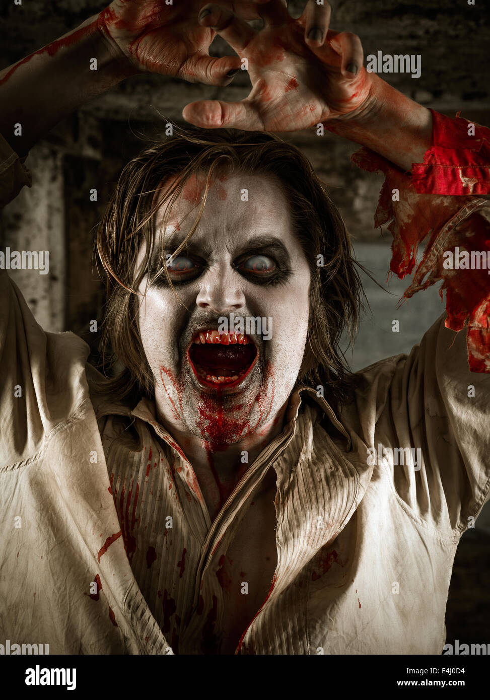 Photo of a hungry zombie covered with blood about to attack you. Stock Photo