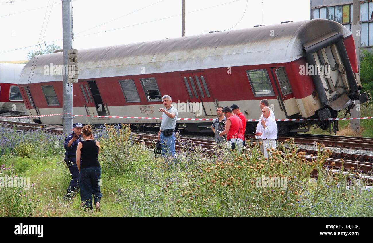 Kalojanovec, Bulgaria. 12th July, 2014. Bulgarian police officers and investigators attend near train crash near the village of Kalojanovec east of the Bulgarian capital Sofia, Saturday, July, 12, 2014. One man died after a train traveling from Sofia to Varna derailed near the central Bulgarian village of Kalojanovec on Saturday, 15:17 EEST (13:17 GMT).The victim was the train's driver.Fifteen pasengers were left injured, two of them in a critical condition, authorities say.Photo by: Petar Petrov/Impact Press Group/NurPhoto Credit:  Petar Petrov/NurPhoto/ZUMA Wire/Alamy Live News Stock Photo
