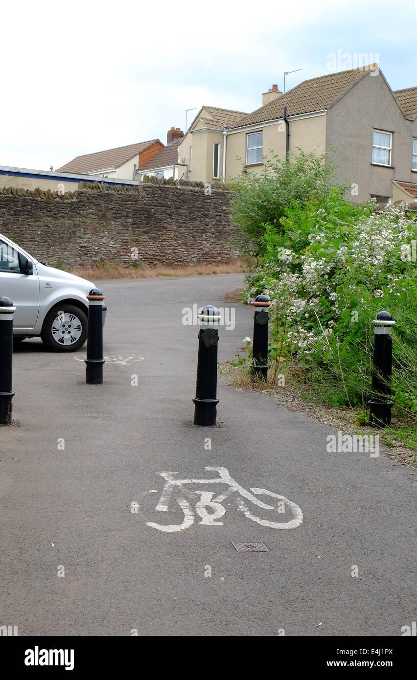 Cycle route defined by marking with bollards to stop the passage of cars and larger vehicles, Winterbourne, June 2014 Stock Photo