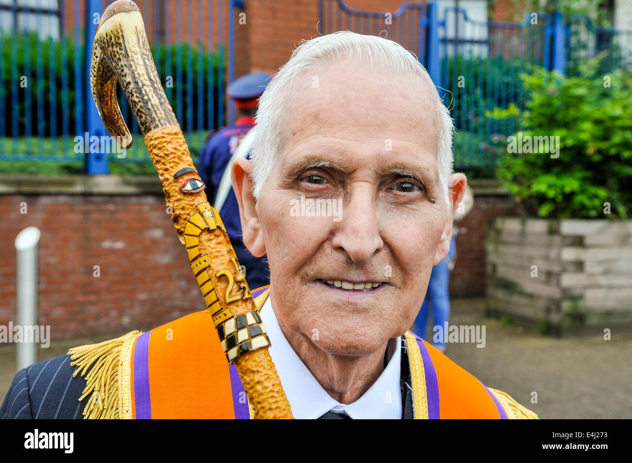 An Orangeman with an ornately carved walking stick, depicting scenes and symbols of the Orange Order. Stock Photo