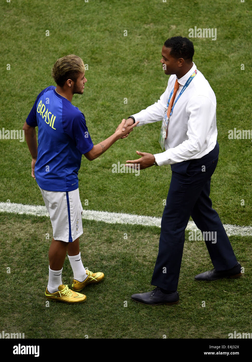 Brasilia, Brazil. 12th July, 2014. Brazil's Neymar (L) shakes hands with Netherlands' assistant coach Patrick Kluivert before the third place play-off match between Brazil and Netherlands of 2014 FIFA World Cup at the Estadio Nacional Stadium in Brasilia, Brazil, on July 12, 2014. Credit:  Lui Siu Wai/Xinhua/Alamy Live News Stock Photo