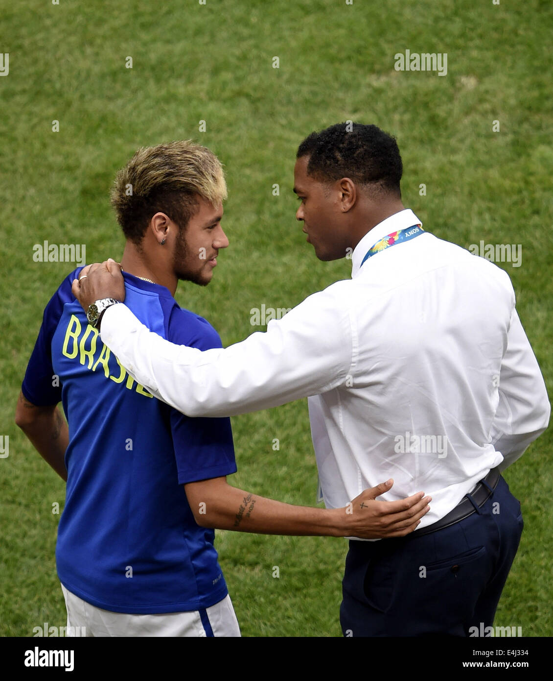Brasilia, Brazil. 12th July, 2014. Brazil's Neymar (L) talks with Netherlands' assistant coach Patrick Kluivert before the third place play-off match between Brazil and Netherlands of 2014 FIFA World Cup at the Estadio Nacional Stadium in Brasilia, Brazil, on July 12, 2014. Credit:  Lui Siu Wai/Xinhua/Alamy Live News Stock Photo