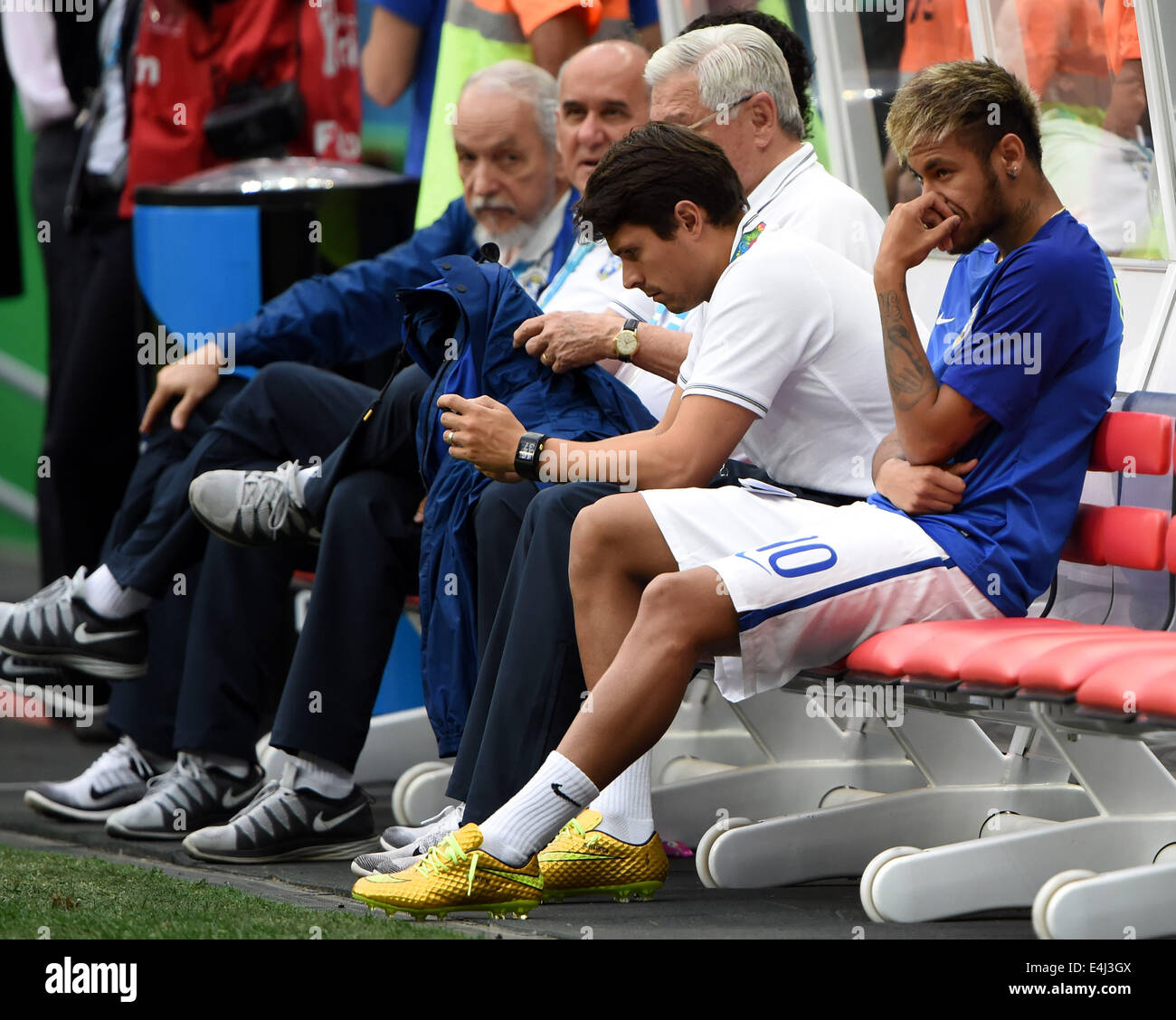 Brasilia, Brazil. 12th July, 2014. Brazil's Neymar (1st R) watches teammates' training on the bench before the third place play-off match between Brazil and Netherlands of 2014 FIFA World Cup at the Estadio Nacional Stadium in Brasilia, Brazil, on July 12, 2014. Credit:  Guo Yong/Xinhua/Alamy Live News Stock Photo
