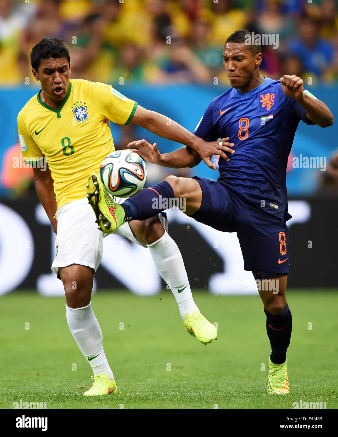 Brasilia, Brazil. 12th July, 2014. Netherlands' Jonathan De Guzman (R) vies with Brazil's Paulinho during the third place play-off match between Brazil and Netherlands of 2014 FIFA World Cup at the Estadio Nacional Stadium in Brasilia, Brazil, on July 12, 2014. Credit:  Guo Yong/Xinhua/Alamy Live News Stock Photo